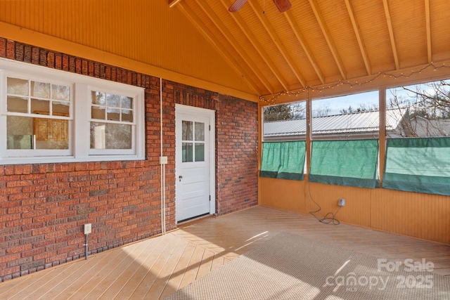 unfurnished sunroom featuring vaulted ceiling with beams and wood ceiling