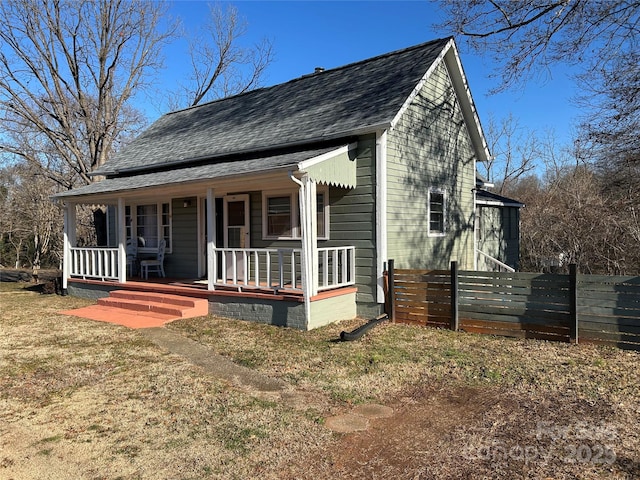 view of front of property with a front yard and a porch