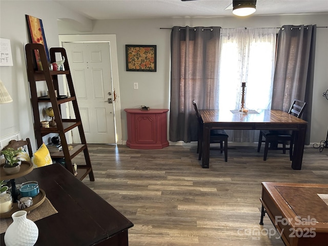 dining space with dark wood-type flooring