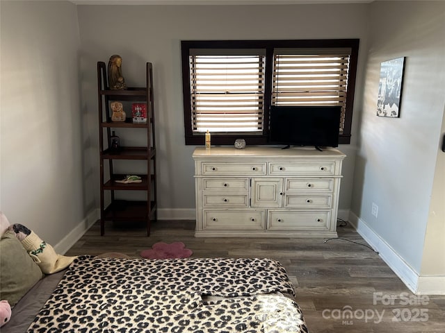 bedroom with dark wood-type flooring