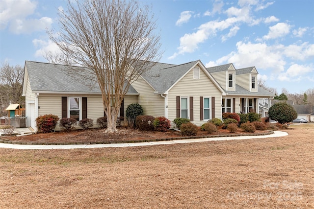 cape cod home with a front yard