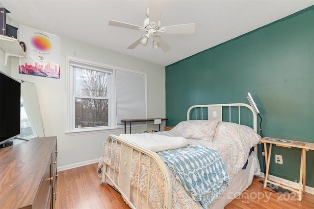 bedroom featuring ceiling fan and light hardwood / wood-style floors