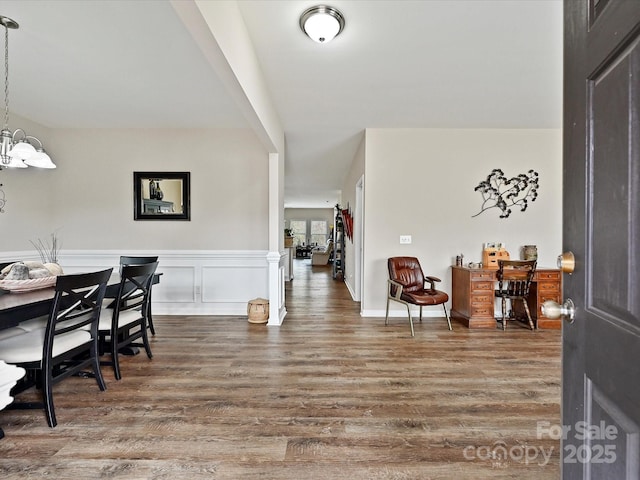 foyer entrance featuring dark wood-type flooring and an inviting chandelier