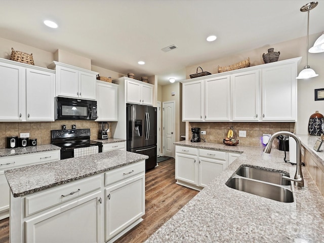 kitchen featuring black appliances, decorative light fixtures, decorative backsplash, and sink