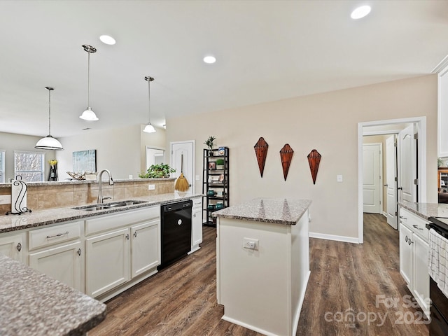 kitchen with sink, white cabinets, light stone counters, a center island, and black dishwasher