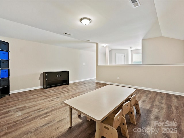 interior space featuring vaulted ceiling and wood-type flooring