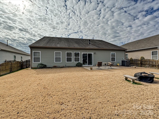 back of property with an outdoor fire pit, a patio area, and cooling unit