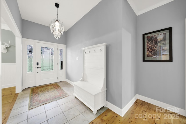 entryway with a chandelier and tile patterned floors