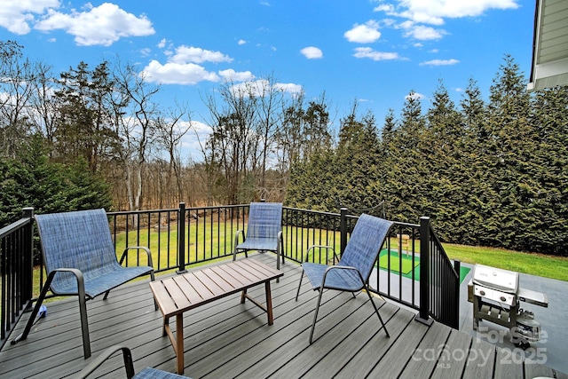 wooden deck featuring a lawn