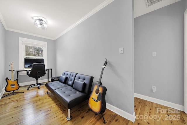 office area with light hardwood / wood-style floors and ornamental molding