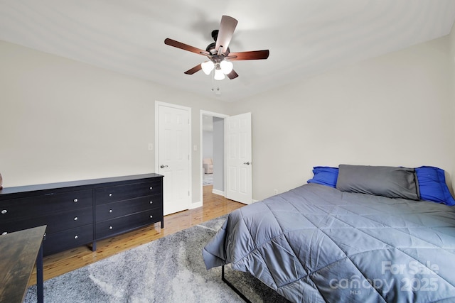 bedroom with ceiling fan and hardwood / wood-style floors