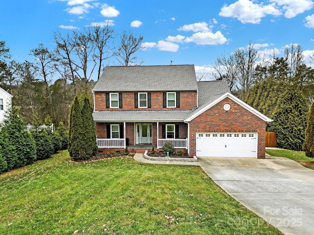 view of front of home featuring covered porch, a front lawn, and a garage