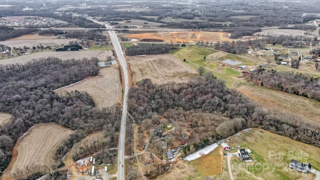 birds eye view of property with a rural view