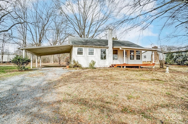 view of front of home featuring a carport and covered porch