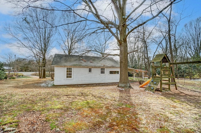 back of property with a playground