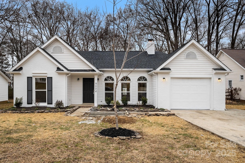 ranch-style house with a front yard and a garage