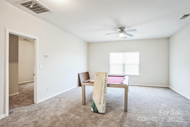 unfurnished dining area featuring carpet and ceiling fan