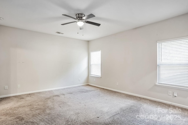 spare room with carpet and ceiling fan