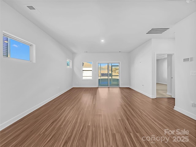 unfurnished living room with wood-type flooring