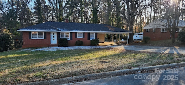 ranch-style house featuring a front yard and a carport