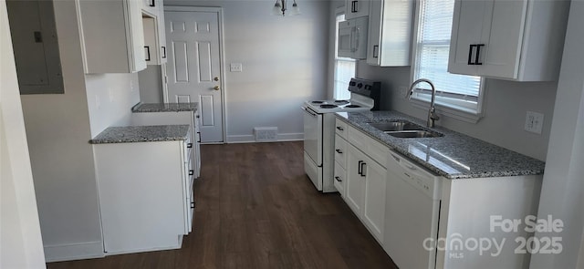 kitchen featuring white appliances, white cabinets, sink, dark hardwood / wood-style floors, and electric panel