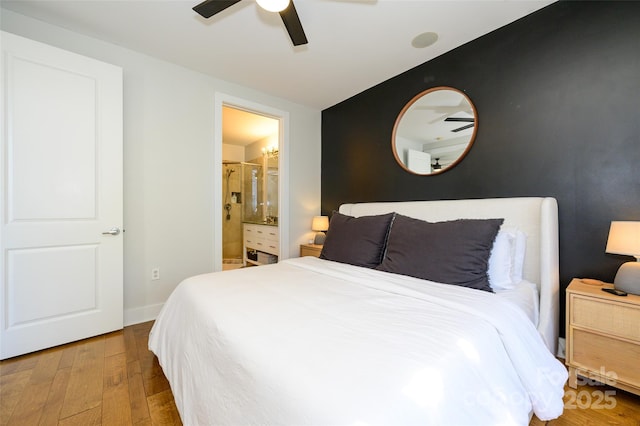 bedroom featuring ceiling fan, ensuite bathroom, and hardwood / wood-style flooring