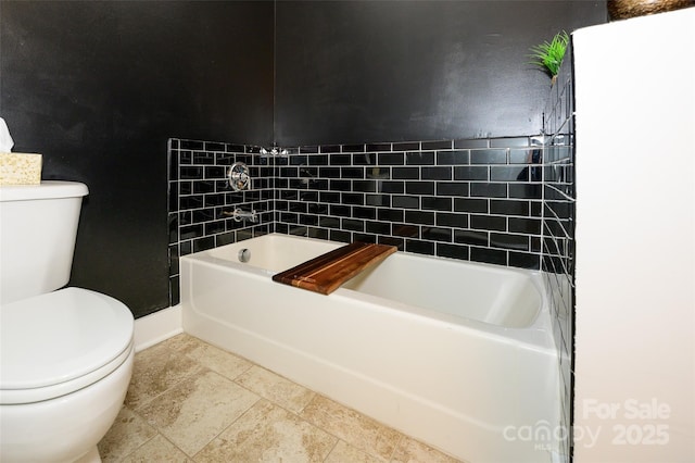 bathroom featuring toilet and a bathing tub