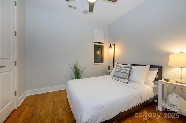 bedroom featuring ceiling fan, dark wood-type flooring, and vaulted ceiling