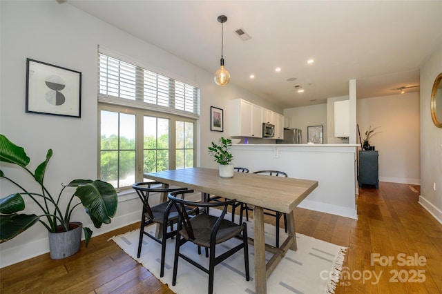 dining area with dark wood-type flooring