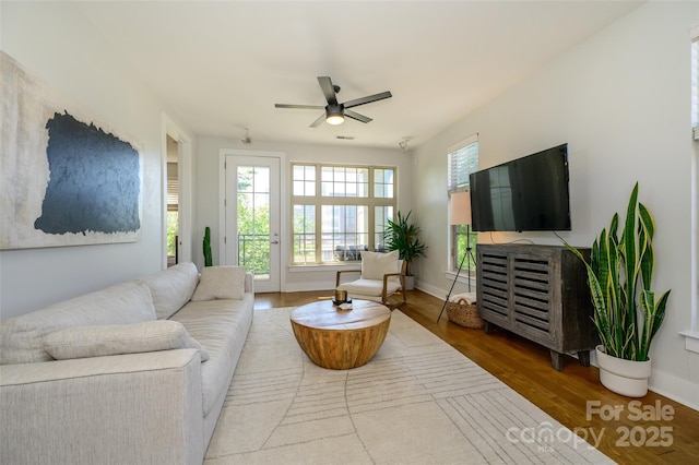 living room featuring ceiling fan and wood-type flooring