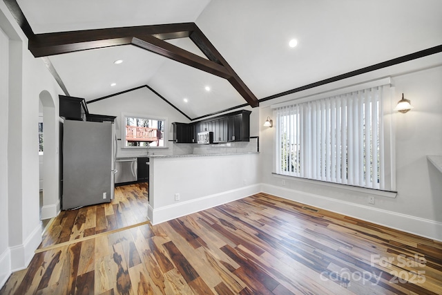 unfurnished living room with vaulted ceiling with beams and dark hardwood / wood-style flooring