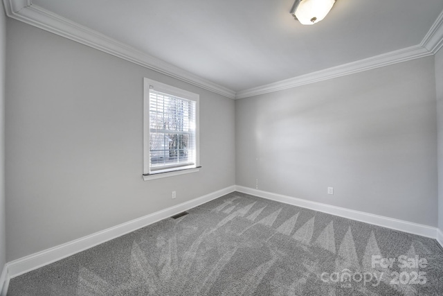 empty room featuring crown molding and carpet flooring