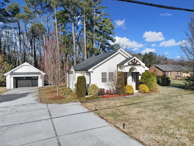 view of front of property featuring an outbuilding, a garage, and a front yard