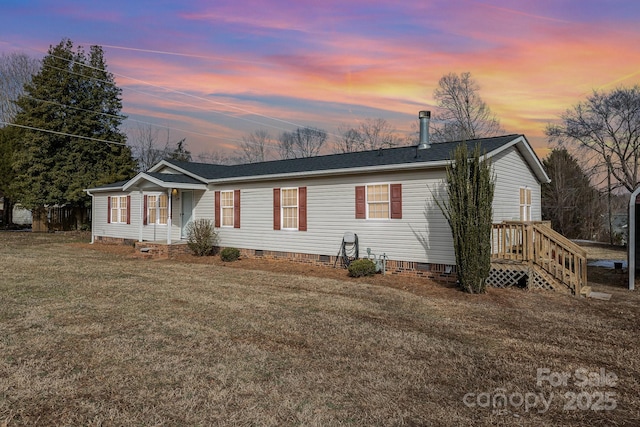 ranch-style home with a yard