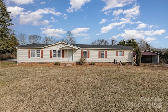 manufactured / mobile home featuring a carport and a front yard