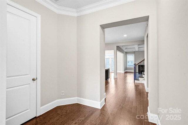 corridor with crown molding, hardwood / wood-style floors, coffered ceiling, and beamed ceiling