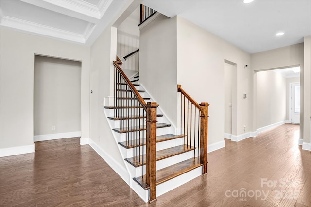 staircase featuring crown molding and hardwood / wood-style floors