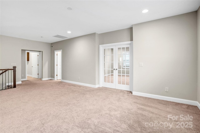 carpeted empty room with french doors