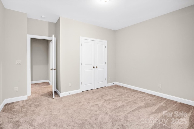 unfurnished bedroom featuring carpet flooring and a closet