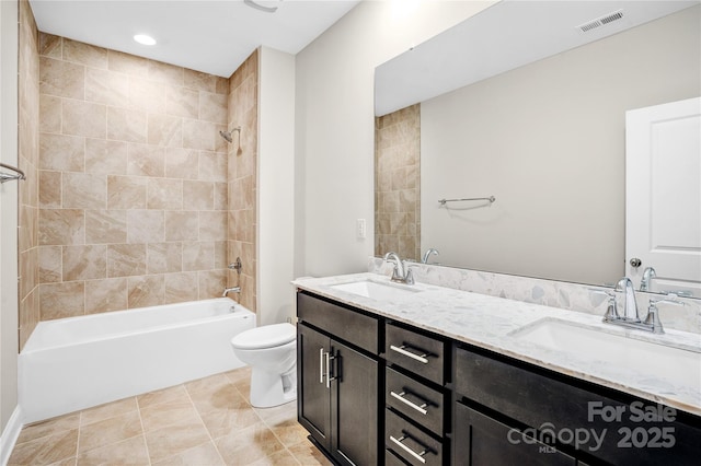 full bathroom with toilet, vanity, tiled shower / bath, and tile patterned flooring