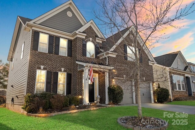 136 Margo Ln, Statesville, NC 28677 - view of front facade featuring concrete driveway, a yard, an attached garage, and brick siding