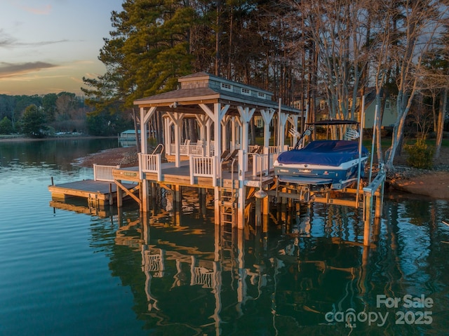 dock area with a gazebo and a water view