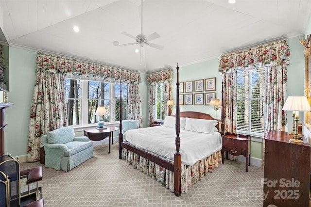 carpeted bedroom with ceiling fan, crown molding, and multiple windows