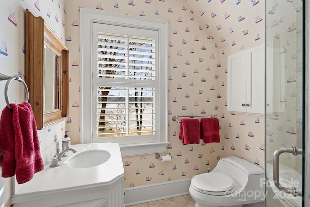 bathroom featuring a shower with shower door, toilet, vanity, and tile patterned flooring