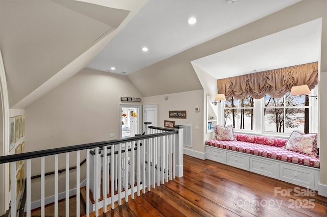 hallway with lofted ceiling and dark hardwood / wood-style flooring