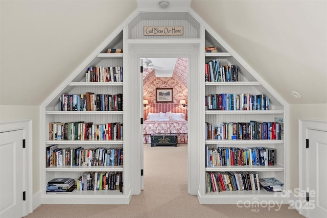 sitting room featuring carpet and built in shelves