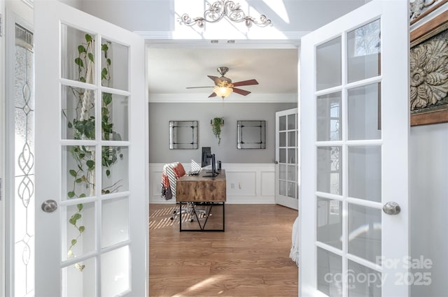 interior space featuring french doors, ceiling fan, ornamental molding, and hardwood / wood-style floors