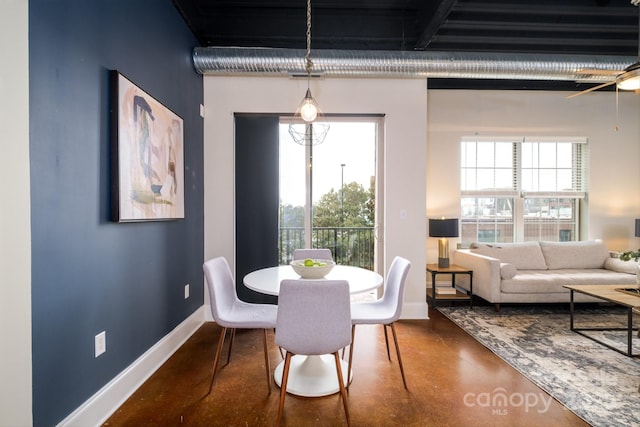 dining space featuring concrete floors