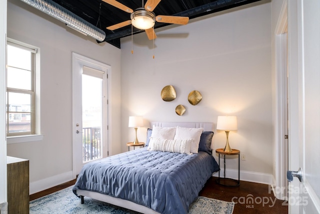 bedroom featuring access to exterior, dark wood-type flooring, and ceiling fan