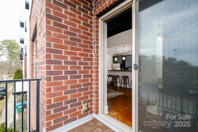 doorway to property featuring a balcony